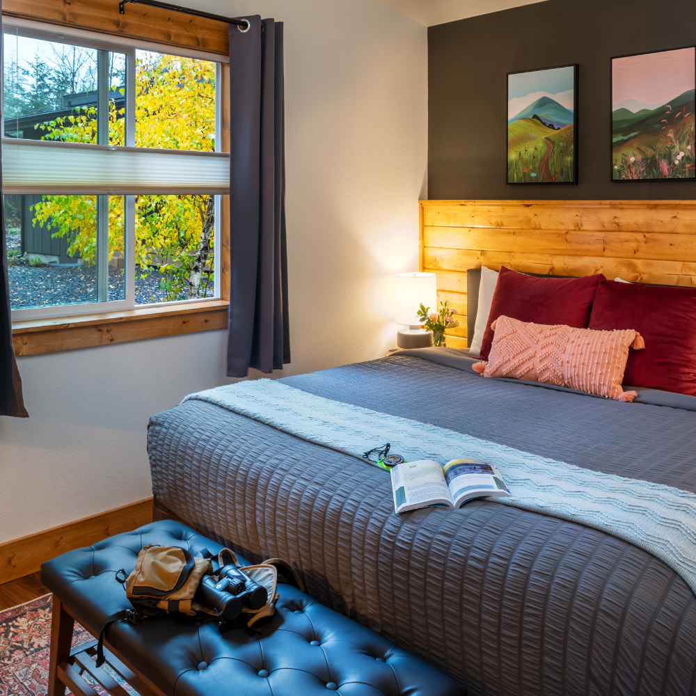 Image of King Bed and luxurious room accommodations at Backwoods Cabins in Carson Washington. View of the forest.