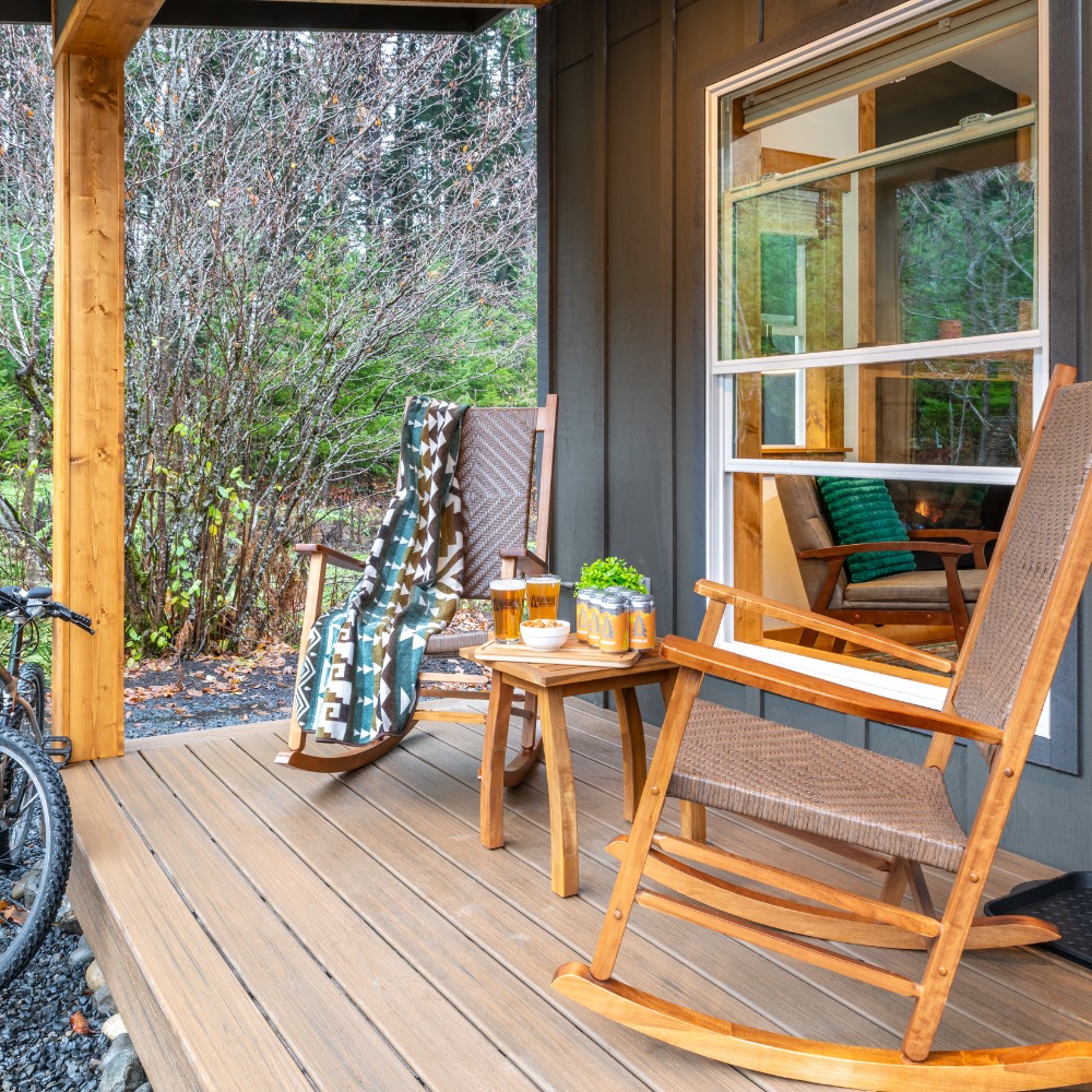 Image fo front porch with two rocking chairs, side table and blanket at cabin at backwoods cabins in carson washington.